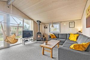 a living room with a couch and a tv at C11216-Hemmet-Ildervej-5 in Hemmet