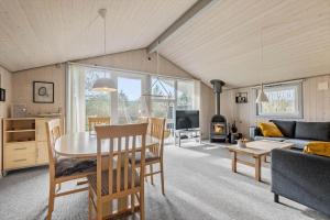 a dining room and living room with a table and chairs at C11216-Hemmet-Ildervej-5 in Hemmet