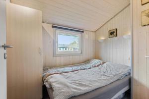 a small bed in a small room with a window at C11216-Hemmet-Ildervej-5 in Hemmet