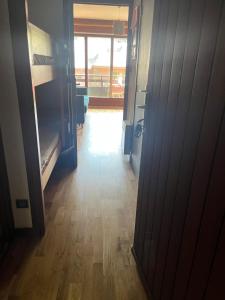 a hallway with a door open to a room with bunk beds at Sunny central studio in Morzine