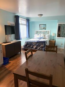 a bedroom with a bed and a table and chairs at Shoreline Suites in Digby