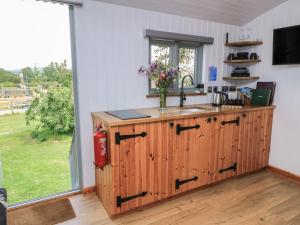 a kitchen with a counter with a sink and a window at Damsons in Taunton +5 photos