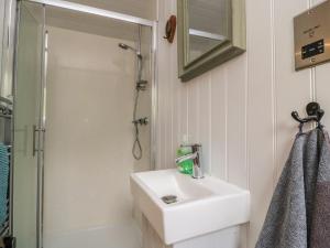 a white bathroom with a sink and a shower at Damsons in Taunton