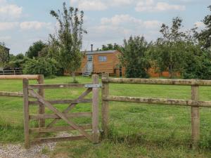 a wooden fence with a gate in front of a house at Damsons in Taunton