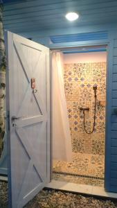 a bathroom with a white door and a shower at Zapach Morza - A Casa Mia in Niechorze