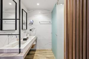 a bathroom with two sinks and a shower at DOM Boutique Hotel in Heraklio +122 photos