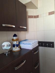 a small kitchen with a counter top with a mirror at Mieszkanie przy plaży Ela in Dziwnów +39 photos