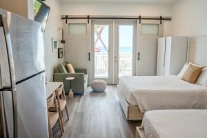 a bedroom with two beds and a refrigerator at Driftwood Inn in Mexico Beach