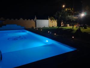 a swimming pool lit up in blue at night at Remedios de Luna in Antimio de Arriba