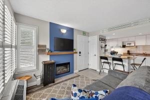 a living room with a couch and a fireplace at Blue Cave Escape - Pool Hot Tub & Shuttle in Blue Mountains