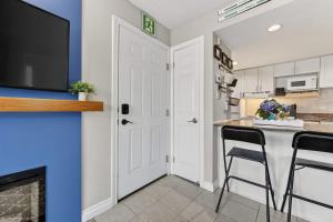 a kitchen with a counter and a table with chairs at Blue Cave Escape - Pool Hot Tub & Shuttle in Blue Mountains +42 photos