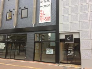 a store with signs on the side of a building at Hotel CASVI Tenjin in Fukuoka