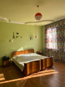 a bedroom with a wooden bed in a room at Quiet house in Buknari +7 photos