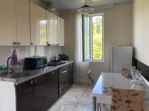 a kitchen with a sink and a counter top at Quiet house in Buknari