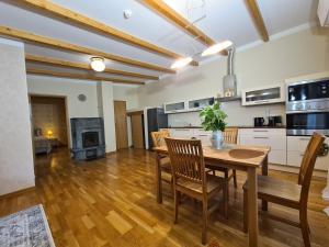 a kitchen and dining room with a wooden table and chairs at 50 ruutmeetrit in Tallinn