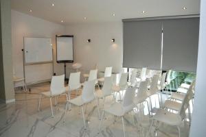 a conference room with white chairs and a board at Diwine Spa House Fruška Gora in Irig +66 photos