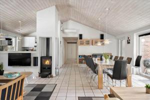 a living room with a table and a fireplace at 1056-Klegod-Lyngvejen-10 in Klegod