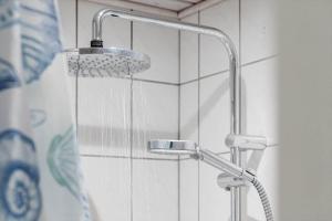 a shower with a shower head in a bathroom at 1056-Klegod-Lyngvejen-10 in Klegod +33 photos