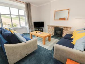 a living room with two couches and a fireplace at Sundale in Strathaven