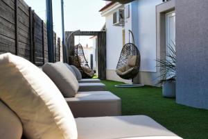 a row of pillows on a balcony with green grass at Casa Reyes El Palmar in El Palmar