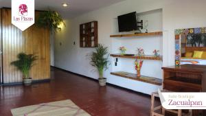 a room with a bed and potted plants in it at Suites Las Plazas in Cuernavaca