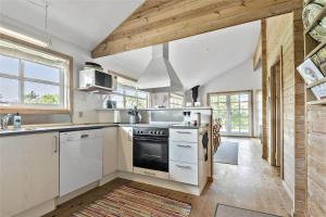 a kitchen with white cabinets and a stove top oven at C11206-Hemmet-Ildervej-7 in Hemmet