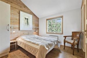 a bedroom with a bed and a chair and a window at C11206-Hemmet-Ildervej-7 in Hemmet