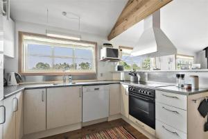a kitchen with a sink and a stove top oven at C11206-Hemmet-Ildervej-7 in Hemmet +18 photos
