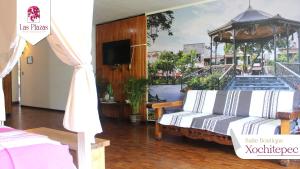 a room with two beds and a tv in it at Suites Las Plazas in Cuernavaca +77 photos