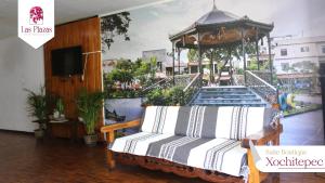 a room with a bed and a gazebo at Suites Las Plazas in Cuernavaca