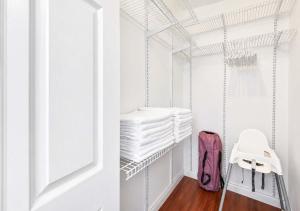 a walk in closet with a stack of towels at The Golfstream Dunes Villa in Hallandale Beach +17 photos