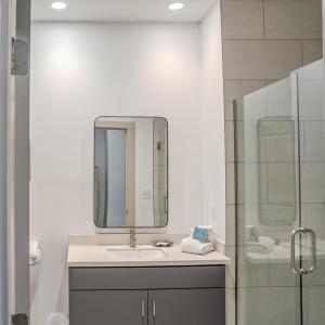 a bathroom with a sink and a mirror and a shower at Driftwood Inn in Mexico Beach +56 photos