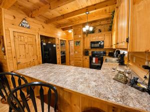 a kitchen with a granite counter top and wooden cabinets at Lords View in Mineral Bluff