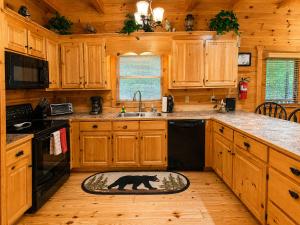 a kitchen with a black bear rug on the floor at Lords View in Mineral Bluff