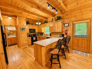 a kitchen with a center island in a wooden cabin at Lords View in Mineral Bluff
