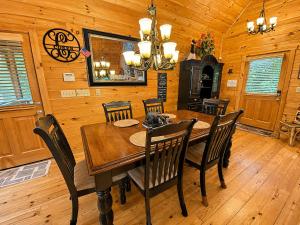 a dining room with a wooden table and chairs at Lords View in Mineral Bluff +24 photos