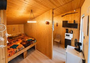 a bedroom with a large bed in a wooden room at Kempink U Šerifa in Protivín