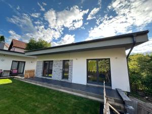 a house with a lawn in front of it at Apartmány Krymlov in Oleška