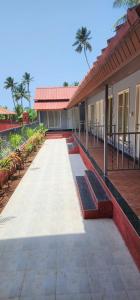 a building with a walkway in front of it at Saavi Resort Shrivardhan in Srīvardhan