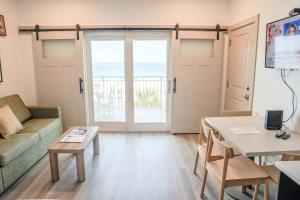 a living room with a couch and a table at Driftwood Inn in Mexico Beach