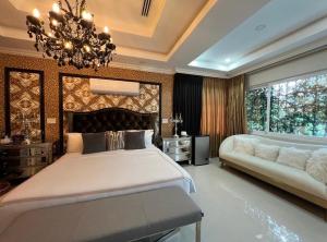 a large bedroom with a large bed and a chandelier at Mansión Versace in Panama City +11 photos