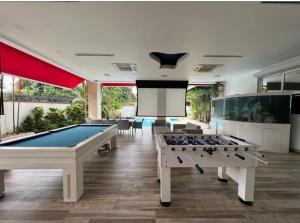 a billiard room with two pool tables and a screen at Mansión Versace in Panama City