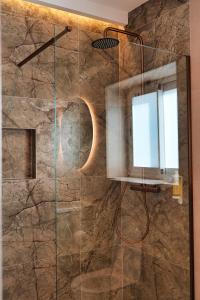 a bathroom with a shower with a glass door at Casa Reyes El Palmar in El Palmar +61 photos