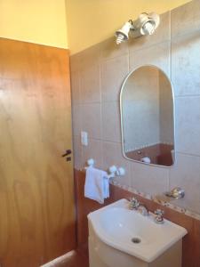 a bathroom with a sink and a mirror at Cabañas Mi Atardecer in Nono +28 photos