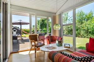 a screened in porch with a table and chairs at 30061-Malling-Morbaervaenget-18 in Malling