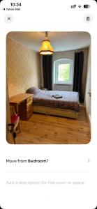 a bedroom with a bed and a desk and a window at Bester Blick auf Bautzen in Bautzen