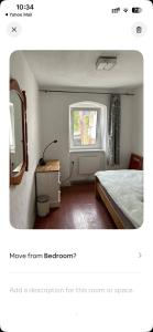 a bedroom with a bed and a mirror and a window at Bester Blick auf Bautzen in Bautzen