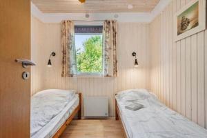 a bedroom with two beds and a window at 30061-Malling-Morbaervaenget-18 in Malling