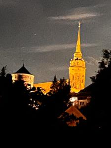 a church with a tall tower with a steeple at night at Bester Blick auf Bautzen in Bautzen +4 photos