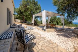 a patio with a table and chairs and a canopy at Amaranthus house in Longós